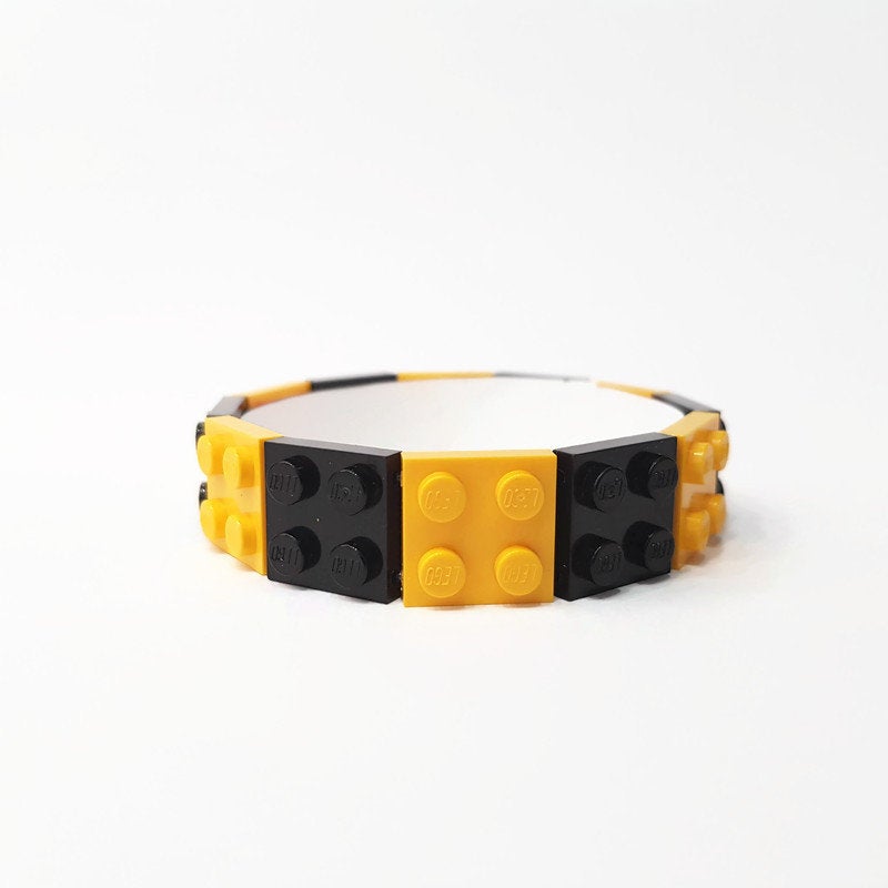 Yellow and black bangle with lego bricks