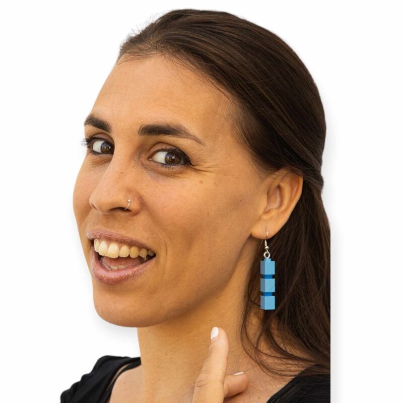 funky lego drop earrings on woman. color light blue