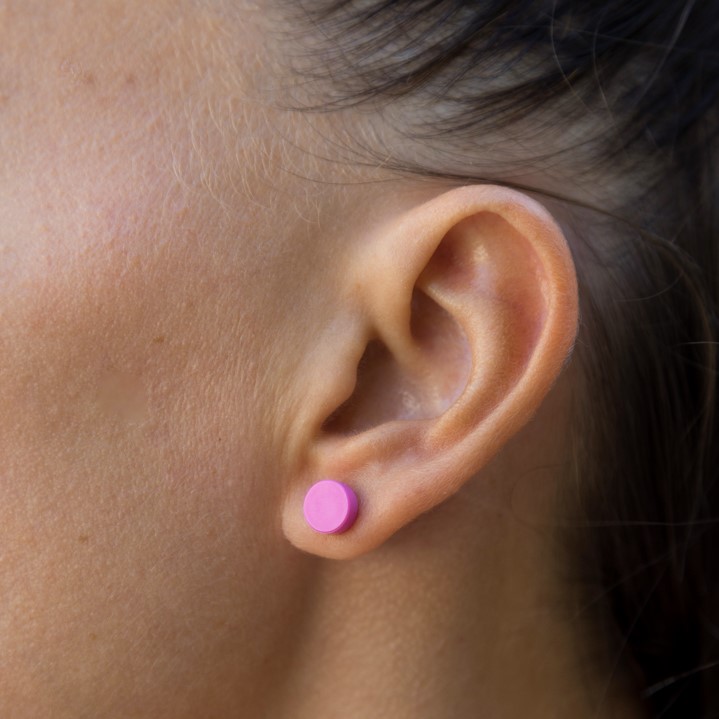 woman wearing a pink lego earring