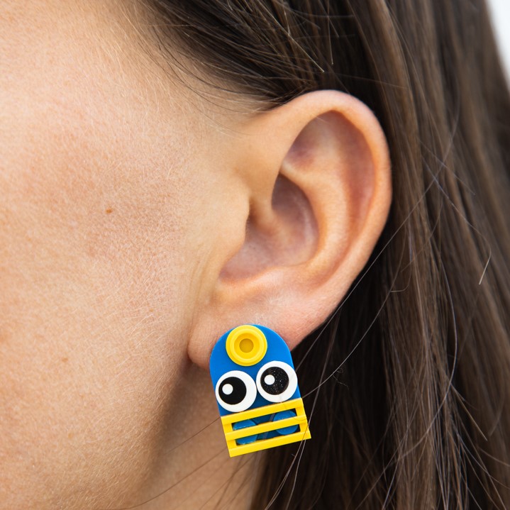 woman wearing coole lego earrings made by thinkbricks