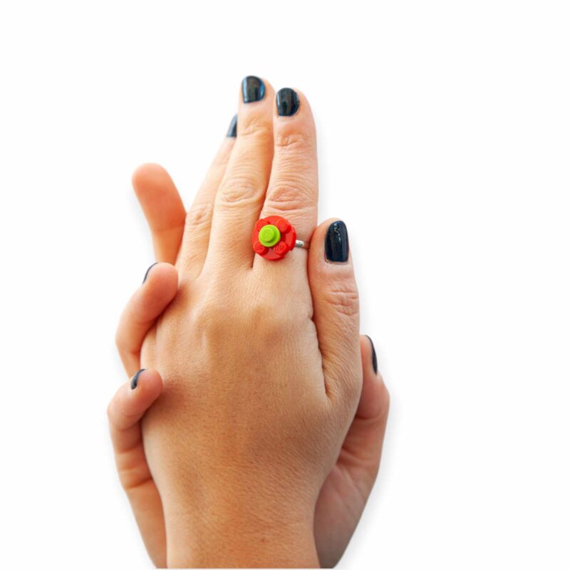 red and lime flower lego ring on fingers